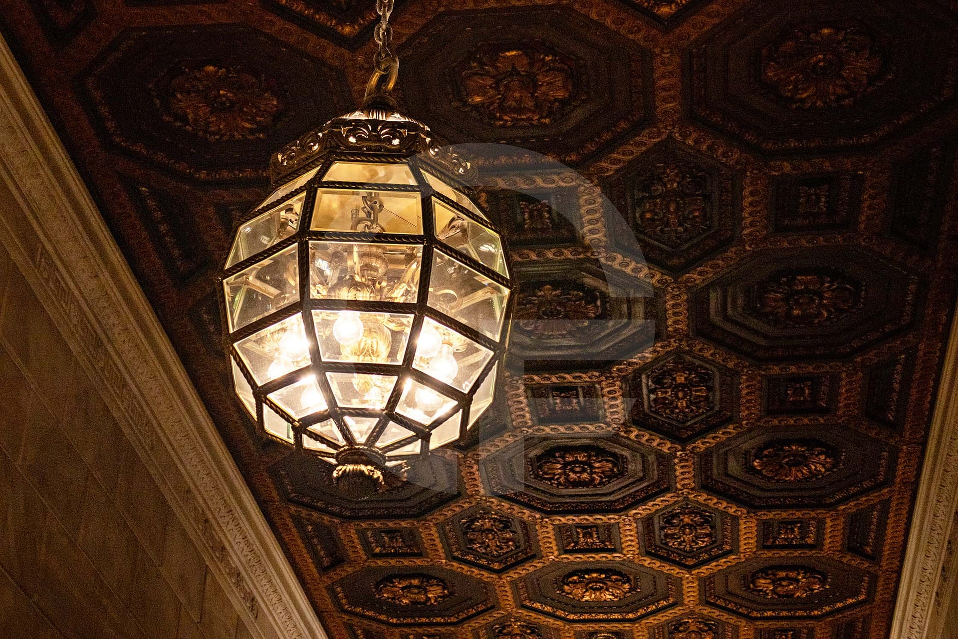 chandelier hanging from ceiling with ornate patterns