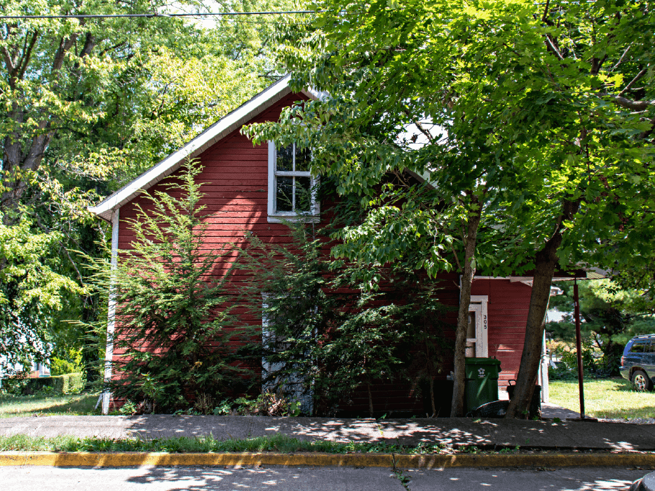 Red house surrounded by trees